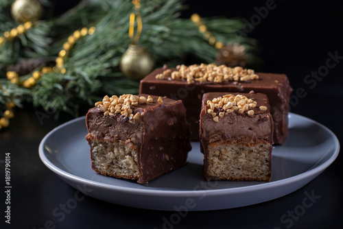Sliced mousse desserts with hazelnut praline, milk chocolate and covered gourmet chocolate-nut glaze on gray plate