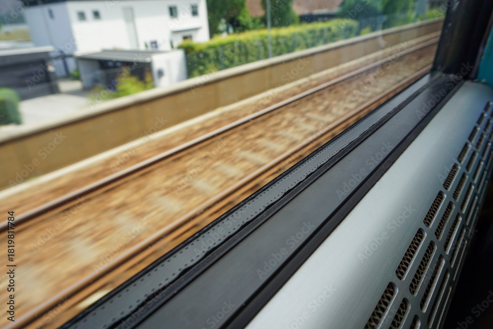 Fototapeta premium View From Moving Train Window: Motion Blur of Railway Tracks and Scenery