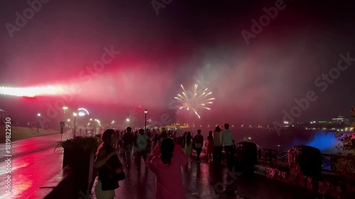 Spectacular fireworks display over Niagara Falls Ontario with glowing mist and vibrant night lights
