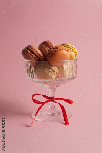 Stacked Colorful Macarons in a Crystal Glass Bowl Tied with a Red Ribbon