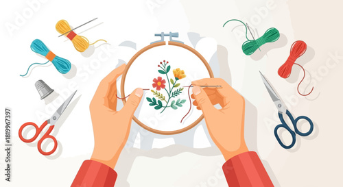 A person engaged in the creative hobby of hand embroidery, stitching a colorful floral pattern onto fabric held in a hoop with surrounding tools
