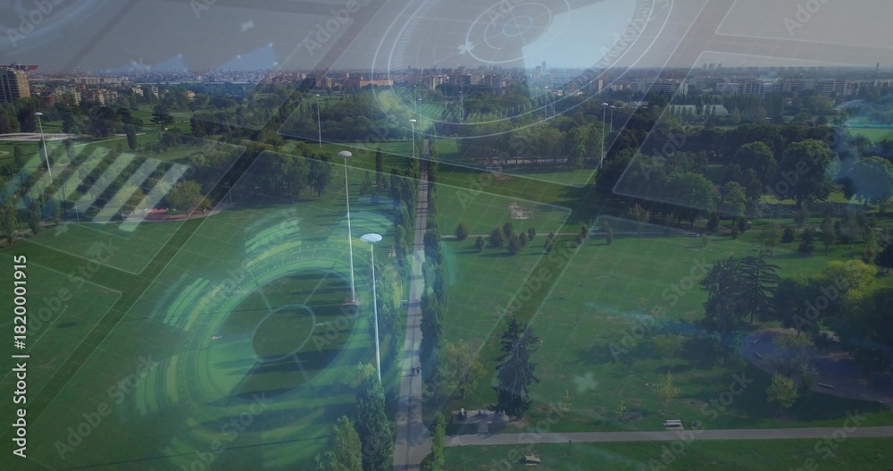 Naklejka premium Stretching central tree-lined walkway through urban park, showing lamp posts, benches, pond and HUD