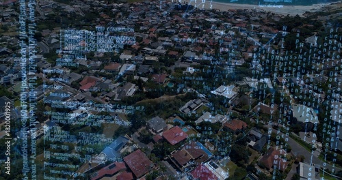 Showing high-altitude coastal neighborhood, displaying detached houses, parked cars, code overlay © vectorfusionart