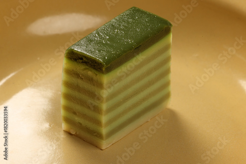 Traditional Malaysian desert Nonyah Kuih making preparing ingredients panadn leaf shredded coconut gula melaka  agar agar sagu spread over black slate messy rustic wood