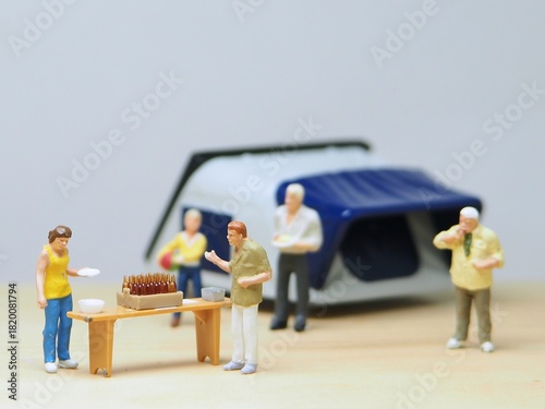 Mini toy of action figure at outdoor with blur background. Miniature photography concept design. Minifigure of traveler character with tent at camping ground. Holiday, vacation and traveling at hill.