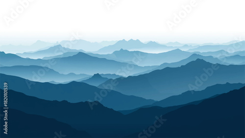 Layered blue mountain ranges fade into a hazy atmospheric distance
