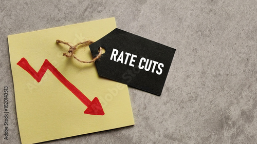 Rate Cuts and Economic Decline: Black Price Tag with Text Over Downward Trend Arrow Graph Symbolizing Interest Rate Reduction