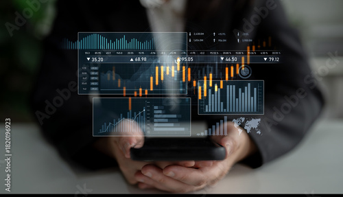 Fotografi A focused businessperson interacts with a mobile device displaying financial data and graphs, symbolizing the integration of technology in trading and market analysis