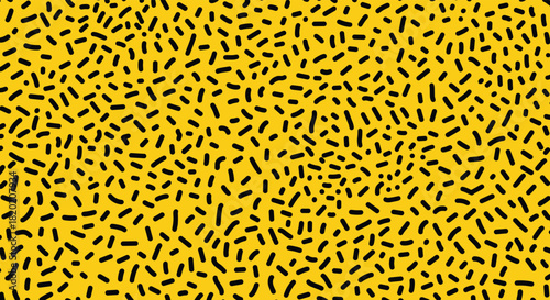 A bright yellow background with a dense pattern of small black dashes.