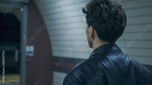 Man in Leather Jacket Waiting at Subway Station