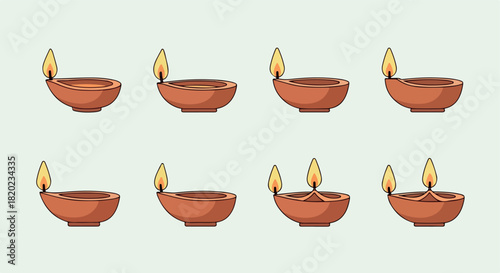 Clay diyas with flames for Diwali celebration