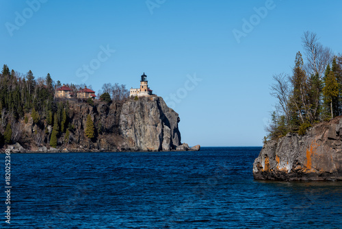 The Split Rock Lighthouse, a popular landmark destination on the North Shore of Lake Superior in Minnesota, is seen on the cliff in the distance, beyond Ellingson Island.