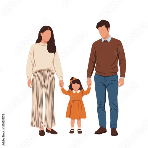 A happy young family with a daughter in the middle, holding hands and smiling in a playful and loving way