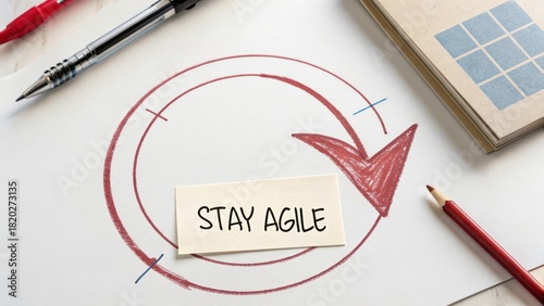 Overhead view of a drawn red arrow and circle with Stay Agile note