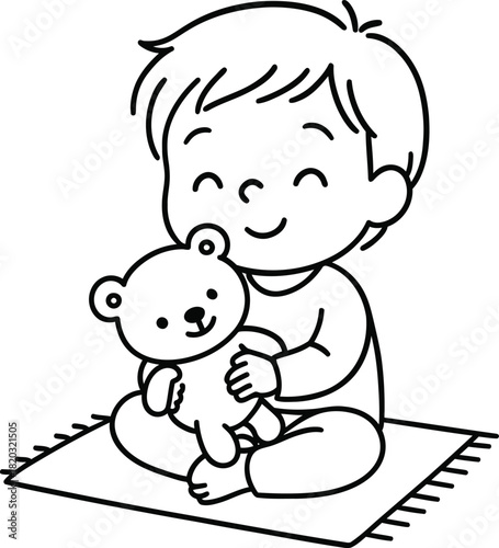 A young boy sitting with a teddy bear on a mat