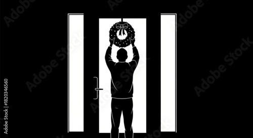 Silhouette of a man from behind hanging a festive Christmas wreath on a front door.