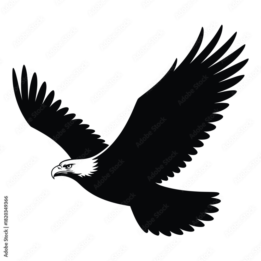 Fototapeta premium A majestic bald eagle in flight, depicted as a powerful black silhouette with a distinctive white head, soaring gracefully