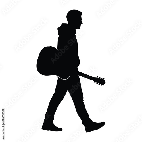 Silhouette of a man walking and carrying an acoustic guitar, representing a musicians journey or performance