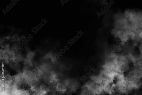 A grayscale image showing a dark background with wisps of smoke or fog at the edges