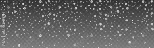 Falling white snowflakes scattered on a transparent background for seasonal and holiday designs