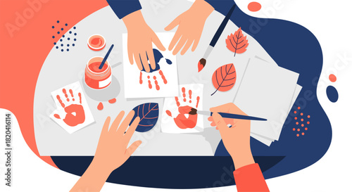 Creative hands-on art project featuring colorful handprints and autumn leaves, fostering fun and imaginative exploration on a white table.