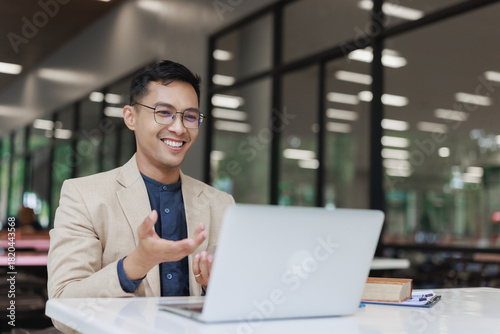 Asian man leading online video business meeting