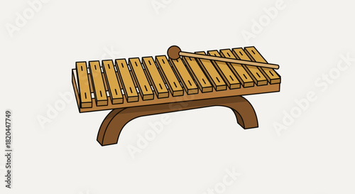 A wooden xylophone with a mallet resting on top, ready to play music.