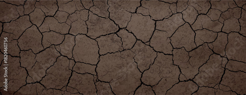 Brown cracked earth background, rustic and textured. The background features brown tones with a dry, rugged appearance. Dry cracked soil texture background. Brown background vector.