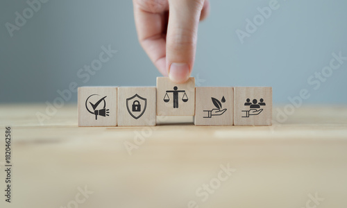 Marketing Ethics and Trust. Wooden blocks with icons of transparency communication, data protection, sustainability, eco-friendly, responsibity, ethics. Ethical marketing and organizational values.