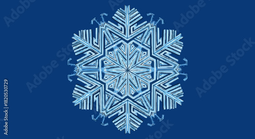 Intricate blue and white snowflake illustration with complex geometric patterns on a dark blue background representing winter's crystalline beauty