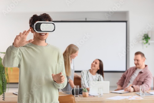 Young man using VR glasses ...