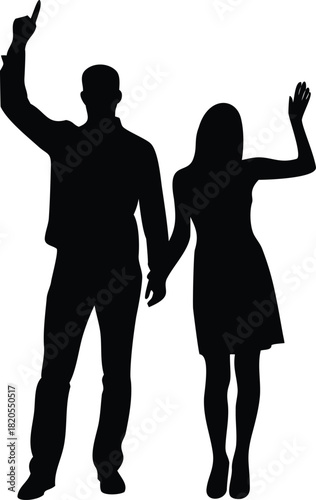 Silhouettes of a couple celebrating holding hands with arms raised in joyful expression