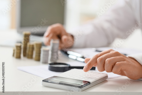 Businessman with stacks of ...