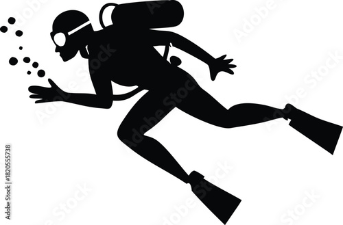 A silhouetted scuba diver swims forward bubbles trailing behind in the dark water