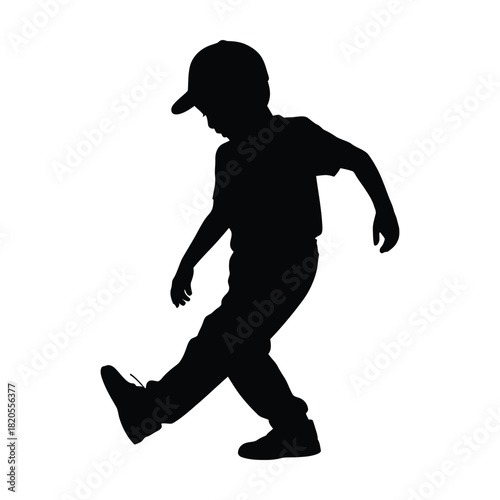 Full length silhouette of a young boy in a cap, walking with a playful step, isolated on