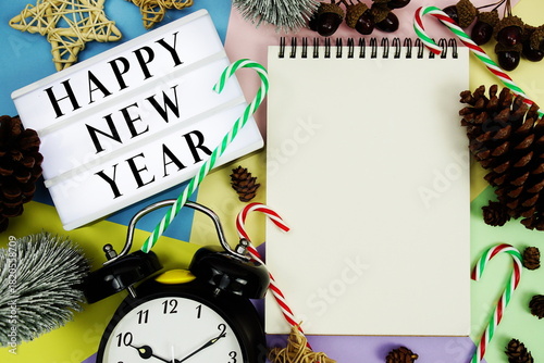 Happy New Year text with Christmas element decoration on pastel background