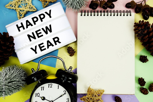 Happy New Year text with Christmas element decoration on pastel background