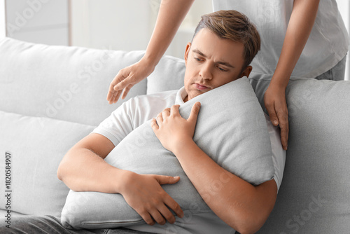 Woman supporting man with s...