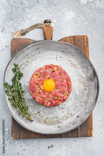 Photos Fresh beef tartare with yolk on stone dish and wooden board great for gourmet cooking protein rich meals and high quality food photography