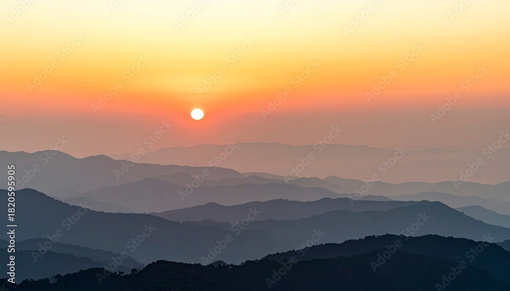 Fototapeta premium Sunrise Over Mountain Ranges - A Serene Landscape.