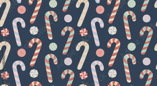 Seamless vector pattern featuring stylized candy canes and swirl candies in muted pastel colors on a dark blue background
