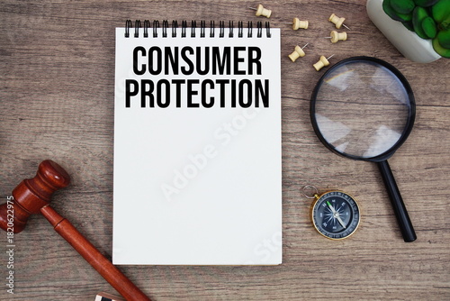 Slika na platnu Consumer Protection message written on notepad with wood gavel and magnifying gl