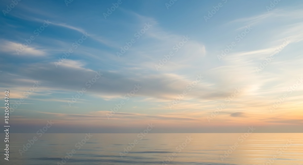 Fototapeta premium Calm ocean waters reflecting soft pastel colors of serene morning or evening sky horizon.