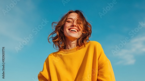 Young woman with a bright smile enjoying a sunny outdoor day.
