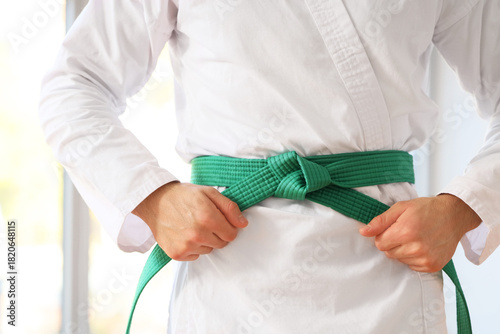 Young man with green belt p...