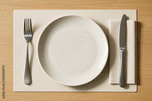 Top view of white plate with fork and knife on napkin over beige placemat on wooden table, minimal clean background for food mockup or design template. Ai generative
