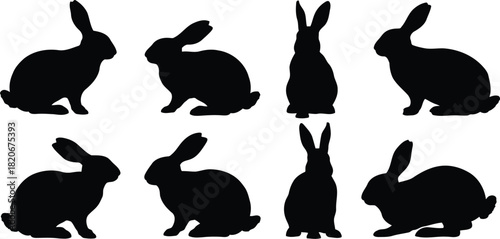 Group of Eight Black Silhouetted Rabbits in Various Positions Posed Against a White Background