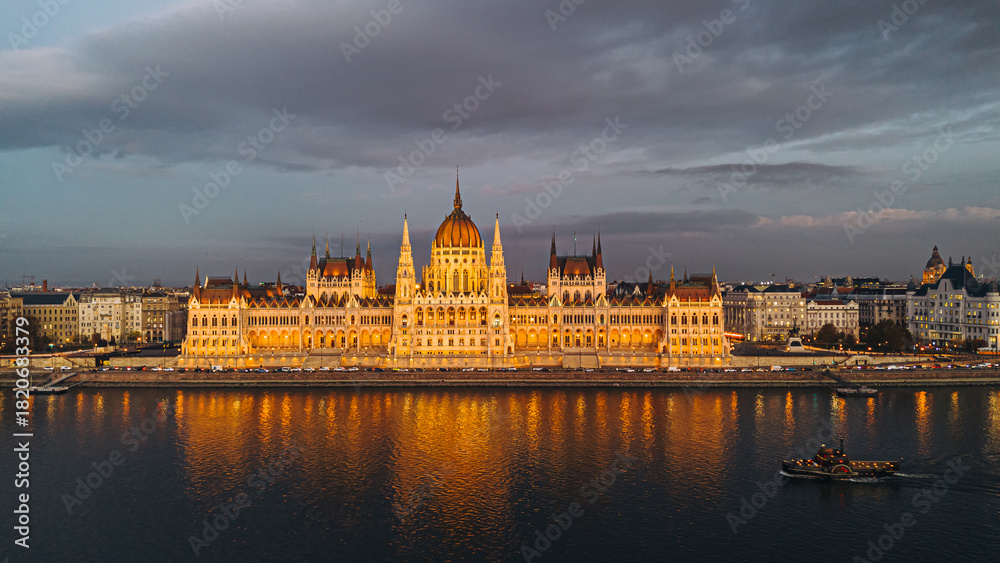 Fototapeta premium Budapest Parliament Building at night with the Danube River reflecting the lights.