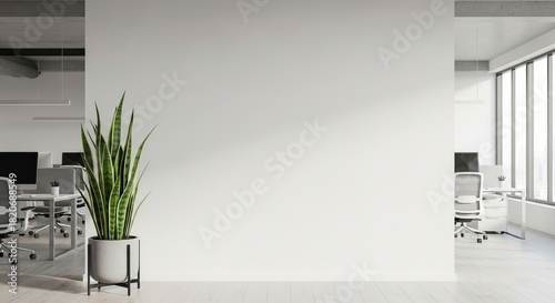 Empty office wall with plant and desks in modern workspace, suitable for advertisements.