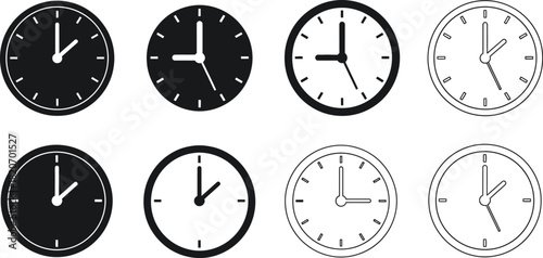 Collection of various analog clocks showing different times in black and white